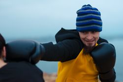 Boxers exercising on cliff