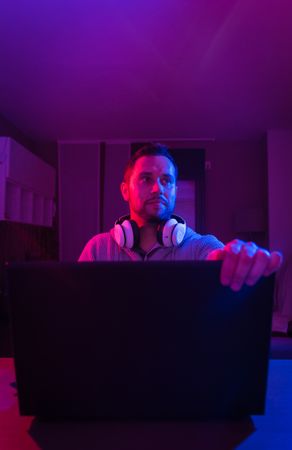 Man listening cheerfully to music with headphones.
