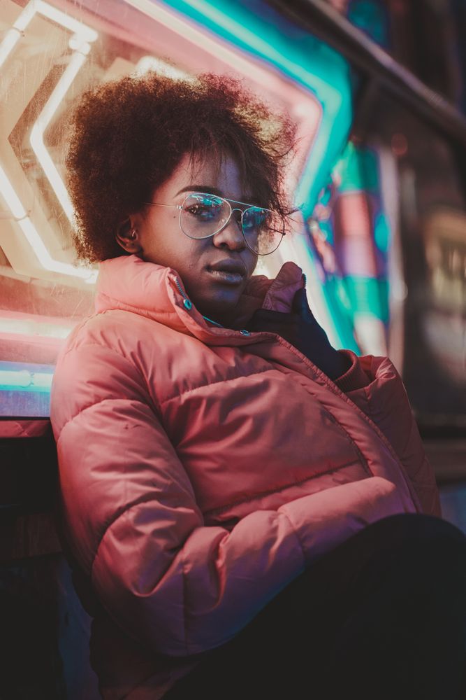 Black woman standing on night city street
