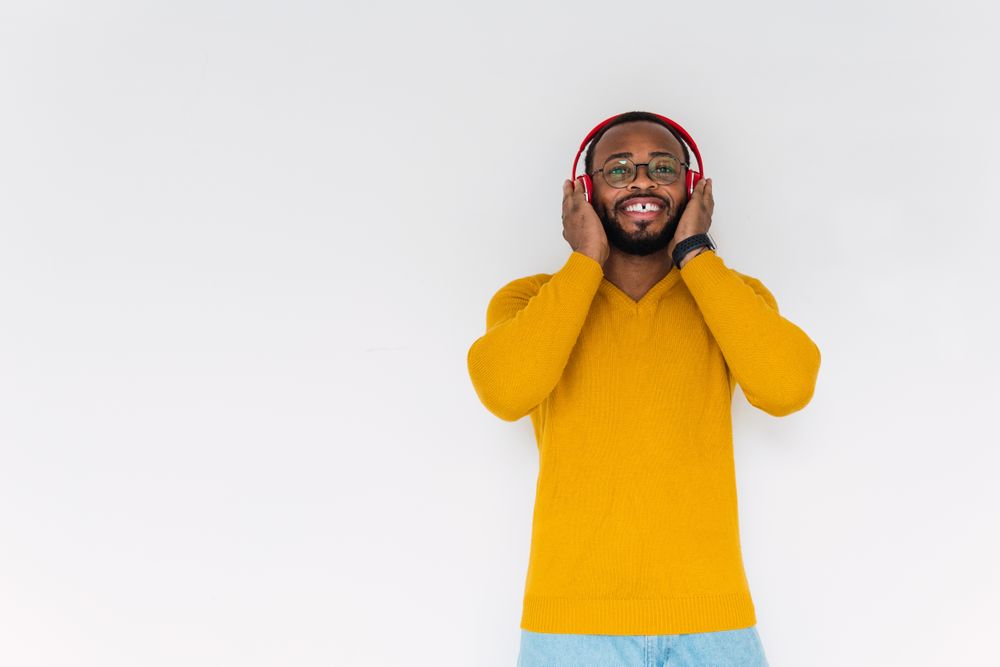 Black man listening to music in headphones