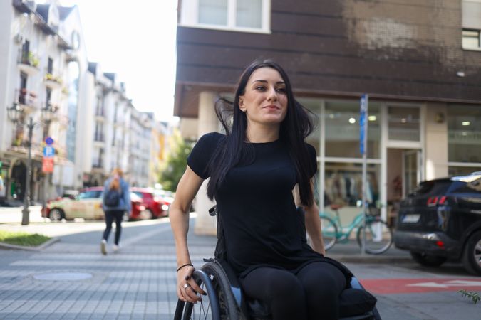 A Woman in a Wheelchair Crossing the Street