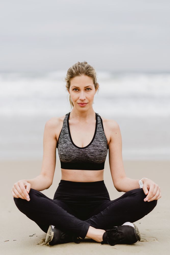 Woman meditating on the beach