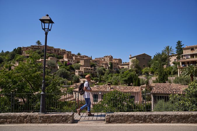 Unrecognizable man walking on pathway in old city