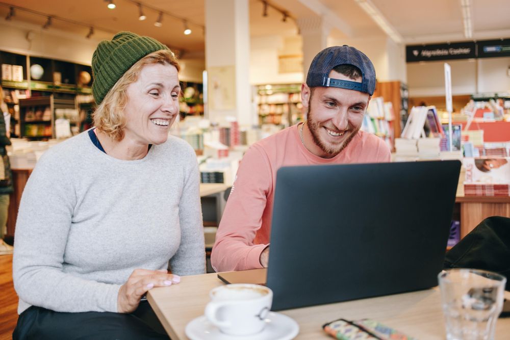 Two people working in cafe