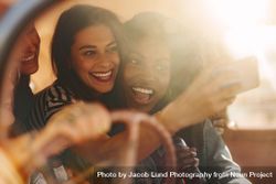 Group of women having fun on the road trip taking a selfie 0KO1Y0