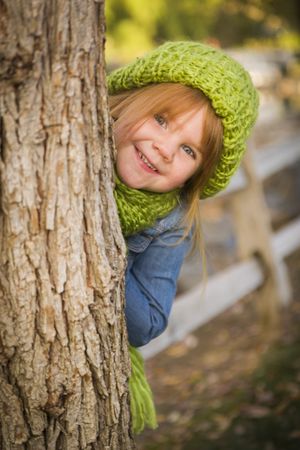 Portrait of Cute Young Girl Wearing Green Scarf and Hat