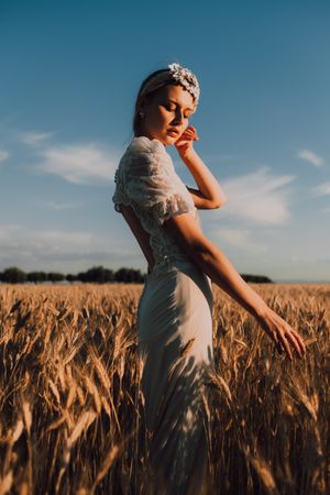 Woman in middle of wheat field