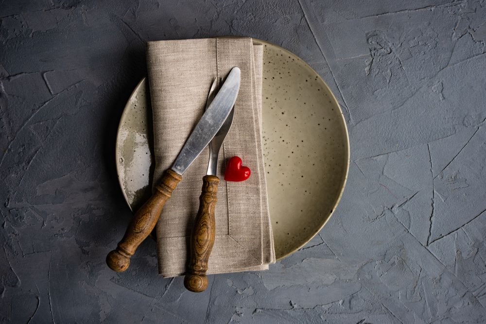 Table setting with beige ceramic plate and heart