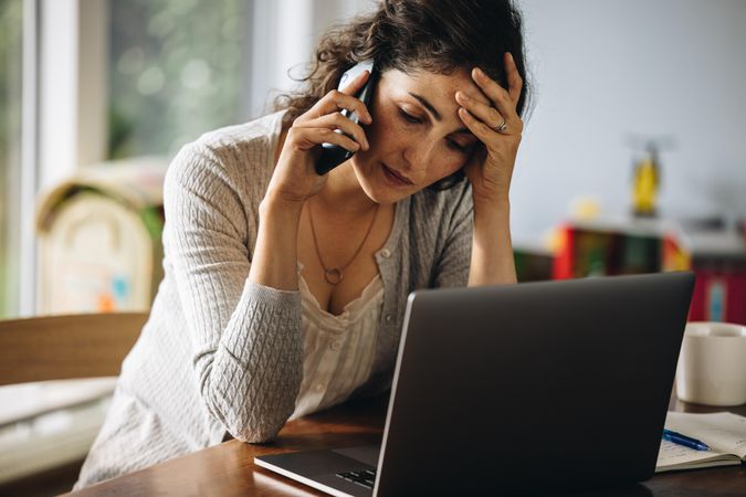 Stressed woman on maternity leave making phone calls