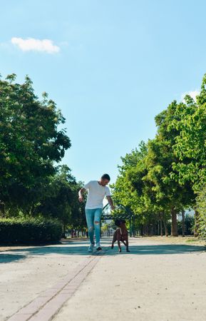 Man running and playing with his dog.