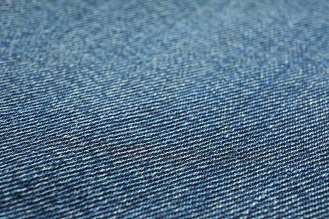 Texture of blue jeans as background, space for text