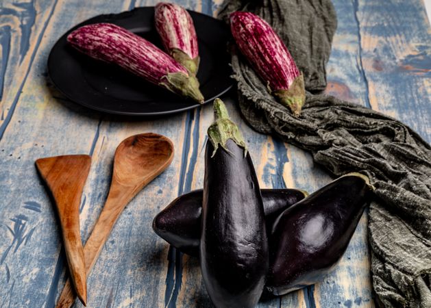Ripe eggplants on shabby tabletop