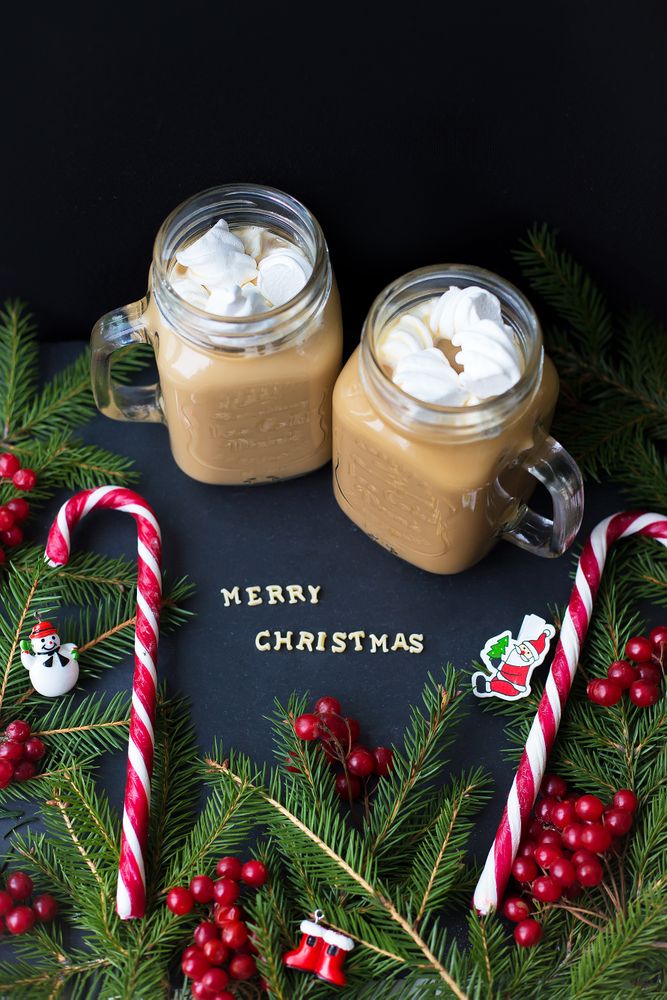 hot cocoa and candy marshmellou on the background of trees. The inscription Merry Christmas