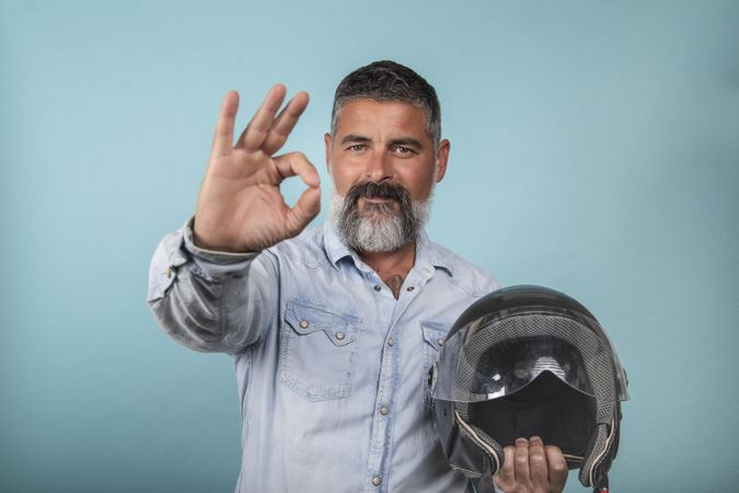 Portrait of bearded man holding motorcycle helmet