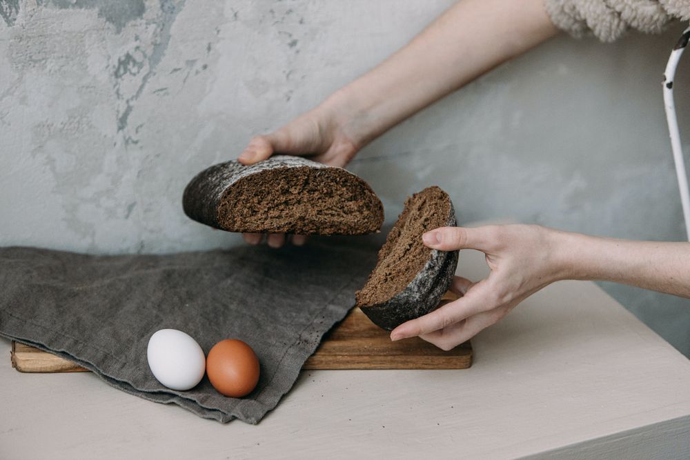 Cropped image of person holding two pieces of bread