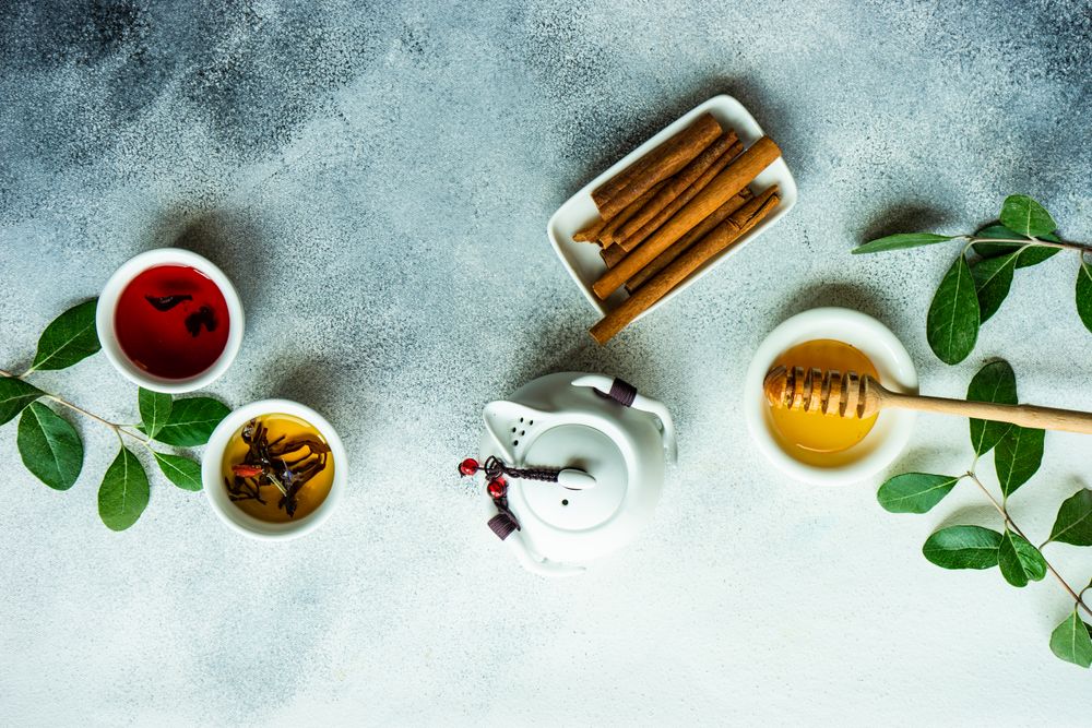 Top view of tea pot with cinnamon with honey