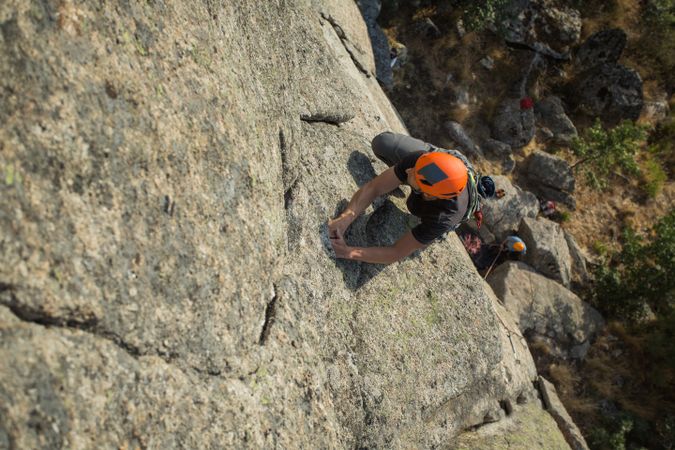 Climbers in safety harness climbing mountain