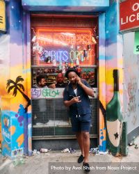 London, England, United Kingdom - August 28, 2022: Man outside liquor store at Notting Hill Carnival 4BlvE0