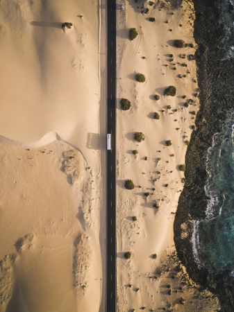 Aerial shot of a road next the shoreline