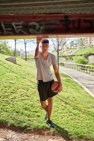 Hispanic man with ball on street