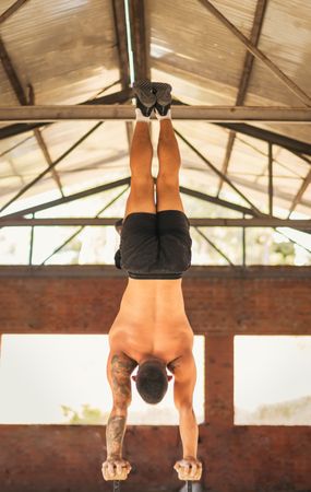 athletic man doing a vertical handstand