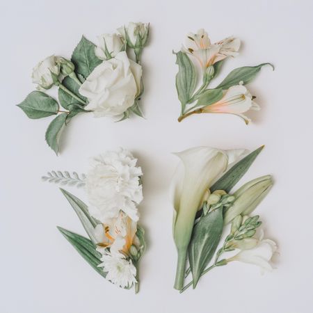 Easter layout with flowers and leaves in cross shape on light paper background