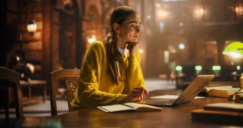 Student Preparing for Exams in a Historic Reading Room, Surrounded by Books.