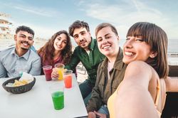 Diverse Friends Taking Selfie at Outdoor Bar
