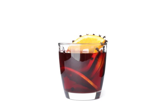Glass of tasty mulled wine with orange isolated on plain background
