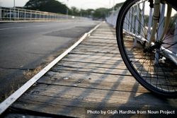 Wheel of a bike on an empty bridge 5zLknb