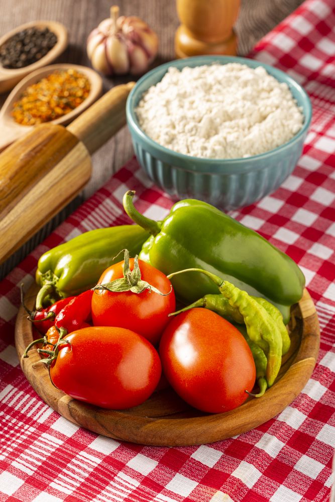 Wooden table with ingredients for pizza.