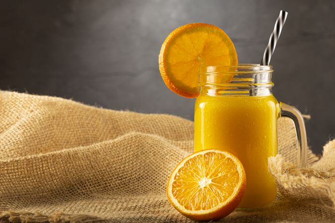 Glass with orange juice on the table.