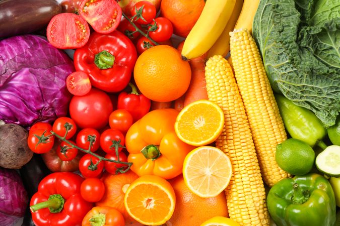 Ripe vegetables and fruits on whole background, close up