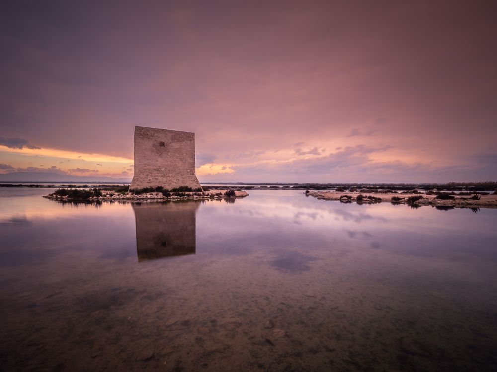Wonderful watchtower in calm lake on cloudy day