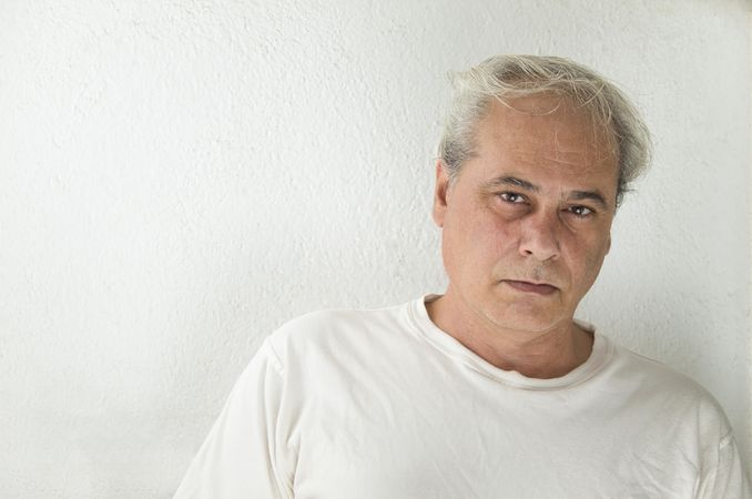 Portrait of disappointed middle aged man in light shirt