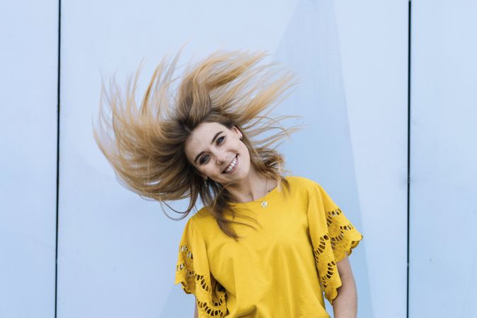 Young woman shaking hair