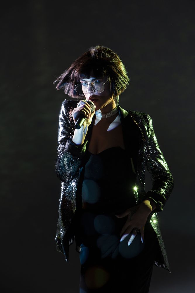 Stylish woman singing on stage