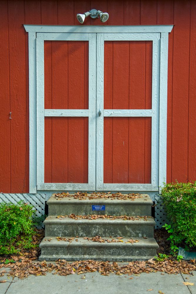 Barn style doors on a red building