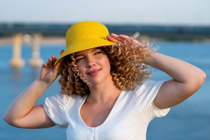 Portrait happy woman in yellow hat outdoors