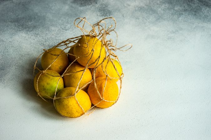 Organic fresh lemons in string bag