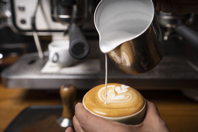 Barista making coffee with latte art