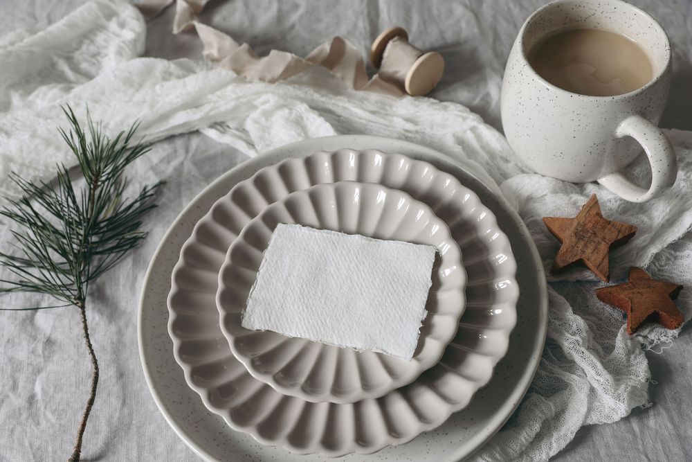 Card, invitation mockup on ceramic plate with pine cone and cookies on tablecloth