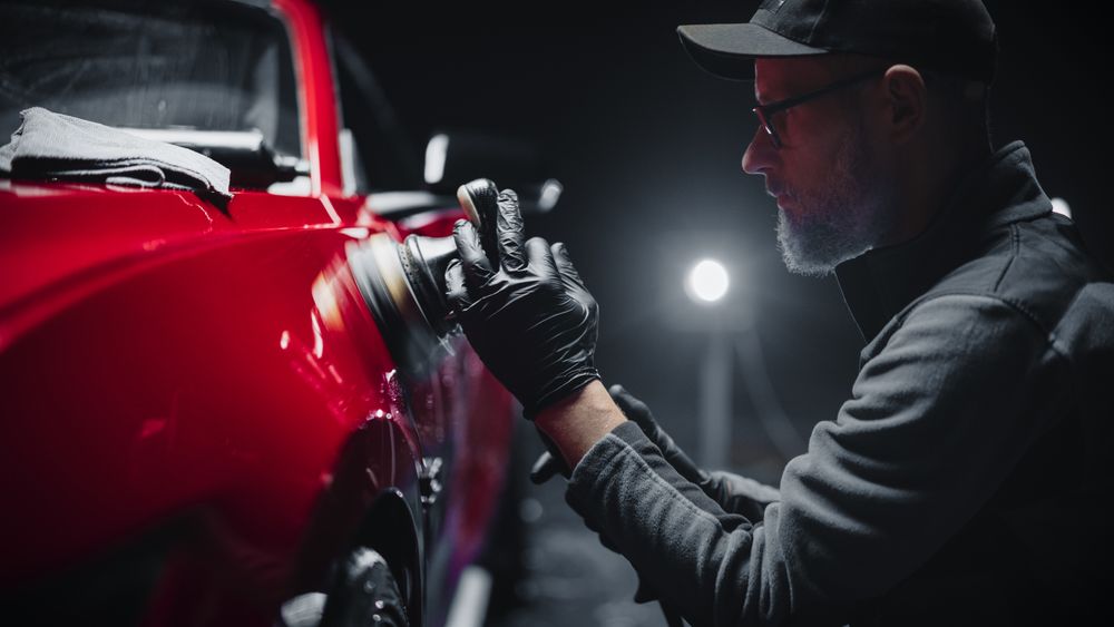 Red Sportscar Standing in a Stylish Detailing Dealership Studio.