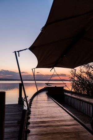 Moored boat by wooden pier