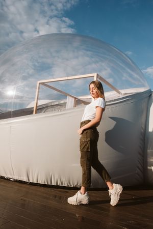 Stylish female standing near bubble hotel