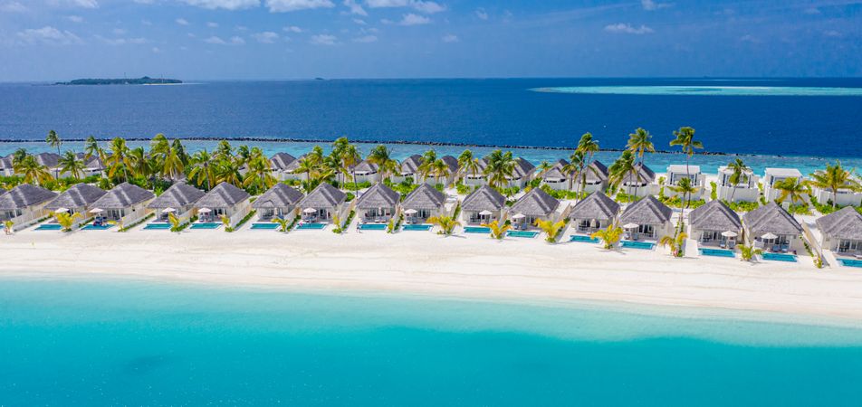 Rows of holiday villas in a tropical beach resort in the Maldives