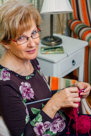 Portrait of woman knitting a wool sweater