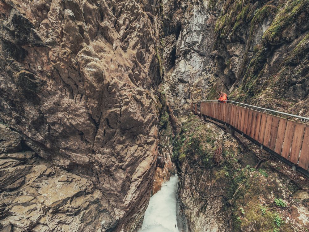 Traveller enjoying picturesque view of mountain ridge