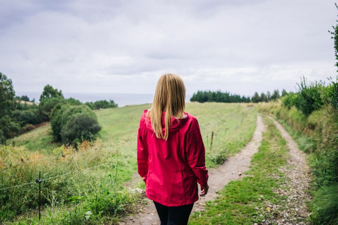 Woman standing in countryside and looking away