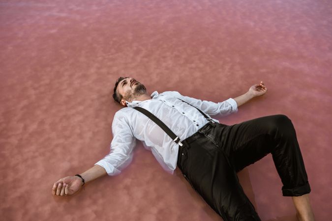 Peaceful man resting in water at seaside